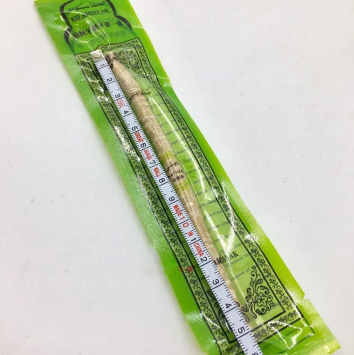 Miswak Tooth Cleaning Stick in packaging, traditional natural wood stick for oral care and teeth cleaning, 15cm length.